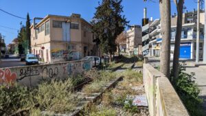 Photo of an abandoned railway overgrown with grass in Piraeus, Greece