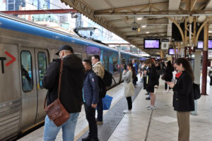 People waiting to board a Comeng train bound for Frankston from Platform 8 at Flinders Street Station, Melbourne.