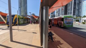 Photo of a tram and bus on either side of the same platform at Broadbeach South Station on the Gold Coast.